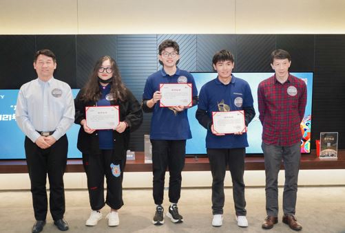 黄建华先生（左一）和吴克安先生（右一）为获奖大学生颁奖